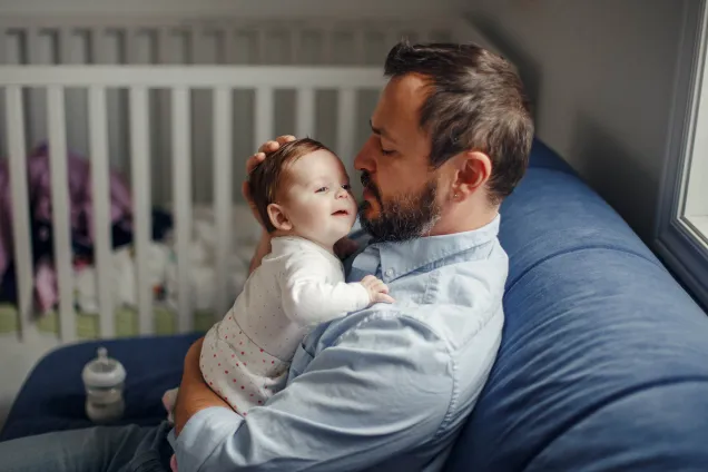dad cuddles baby