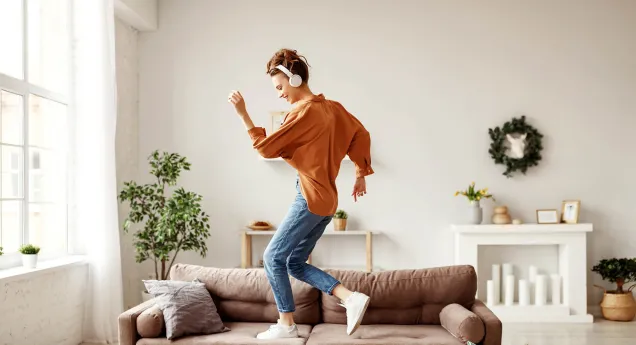 woman dancing on sofa