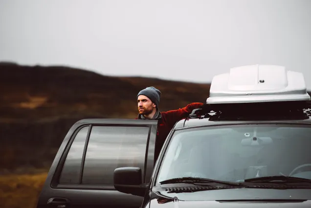 explorer looks at nature from car