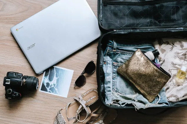 small suitcase sunglasses laptop camera